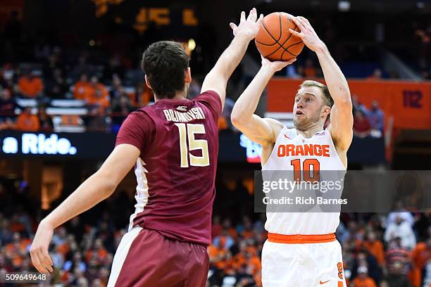 Trevor Cooney of the Syracuse Orange shoots the ball against the defense of Boris Bojanovsky of the Florida State Seminoles during the second half at...