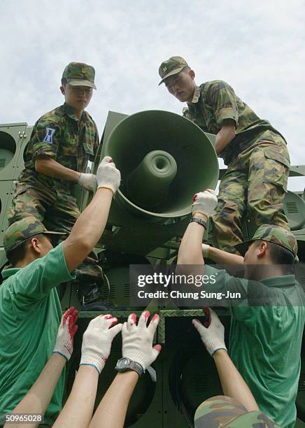 South Korean soldiers take down a battery of propaganda loudspeakers on the border with North Korea on 16 June 2004 in Paju, South Korea. The removal...