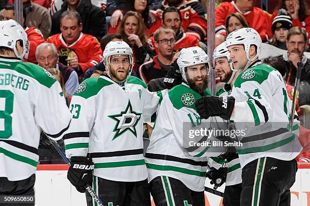 Patrick Eaves of the Dallas Stars celebrates with Mattias Alex Goligoski and Jamie Benn after scoring his second goal against the Chicago Blackhawks...