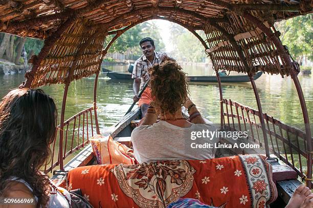 a couple on a guided boat ride in india. - altwasser wasser stock-fotos und bilder