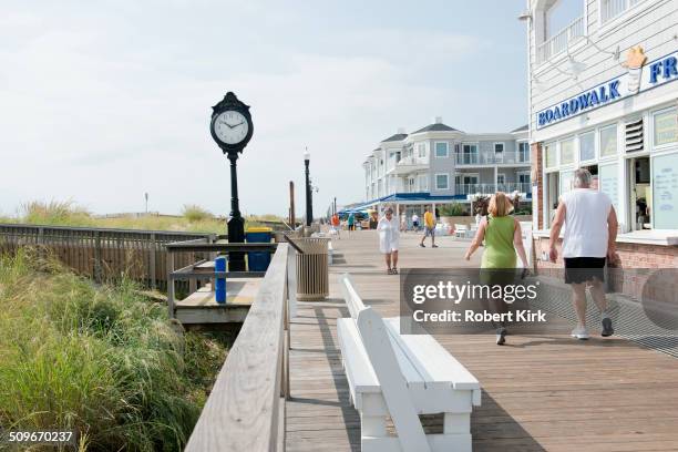 Bethany Beach, Delaware, USA, August 21, 2014: Beach visitors enjoying walks on the boardwalk in late August