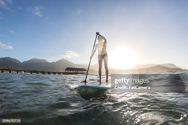 attractive hawaiian female surfer at the beach - hanalei stock pictures, royalty-free photos & images