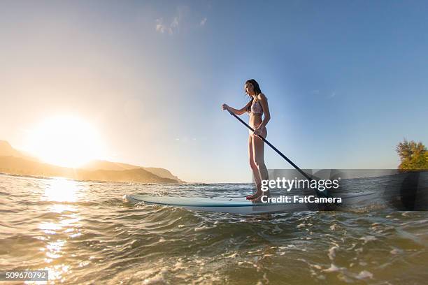 attractive hawaiian female surfer at the beach - hanalei national wildlife refuge stock pictures, royalty-free photos & images