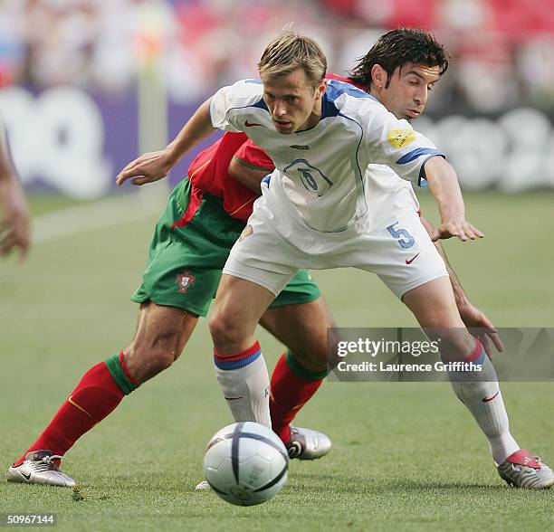 Luis Figo of Portugal clashes with Andrey Karyaka of Russia during the UEFA Euro 2004, Group A match between Russia and Portugal at the Luz Stadium...