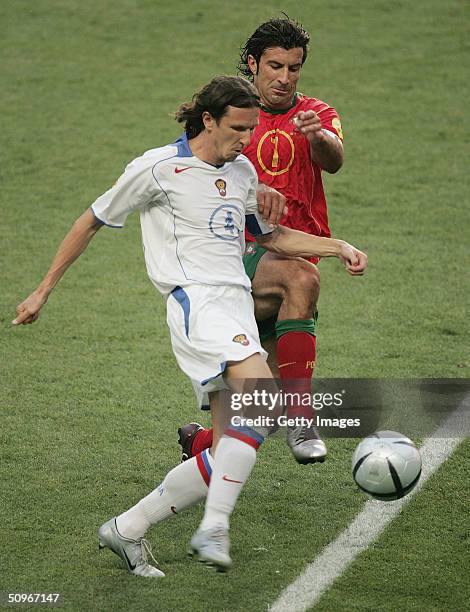 Luis Figo of Portugal battles with Alexei Smertin of Russia during the UEFA Euro 2004, Group A match between Russia and Portugal at the Luz Stadium...