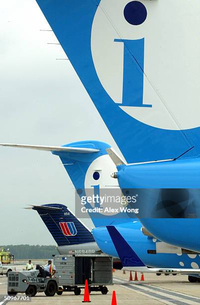 The tails of two Independence Air planes and a United Airlines plane are seen June 16, 2004 at Dulles Airport in Virginia outside Washington, DC....