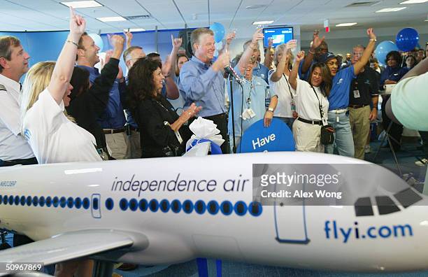 Independence Air Chairman and CEO Kerry Sheen leads a toast with fellow employees during a launching ceremony June 16, 2004 at Dulles Airport in...