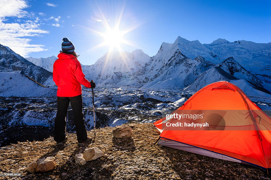 Woman watching sunrise in Himalayas, Mount Everest National Park