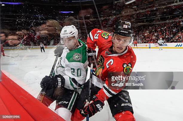Cody Eakin of the Dallas Stars and Jonathan Toews of the Chicago Blackhawks work to get the puck away from the boards in the third period of the NHL...