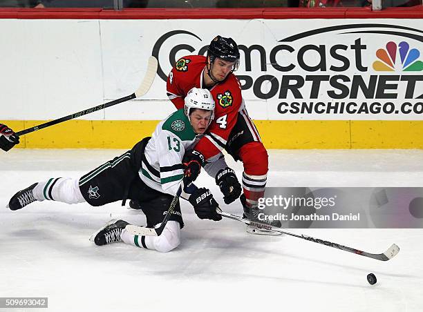 Niklas Hjalmarsson of the Chicago Blackhawks takes down Mattias Janmark of the Dallas Stars at the United Center on February 11, 2016 in Chicago,...