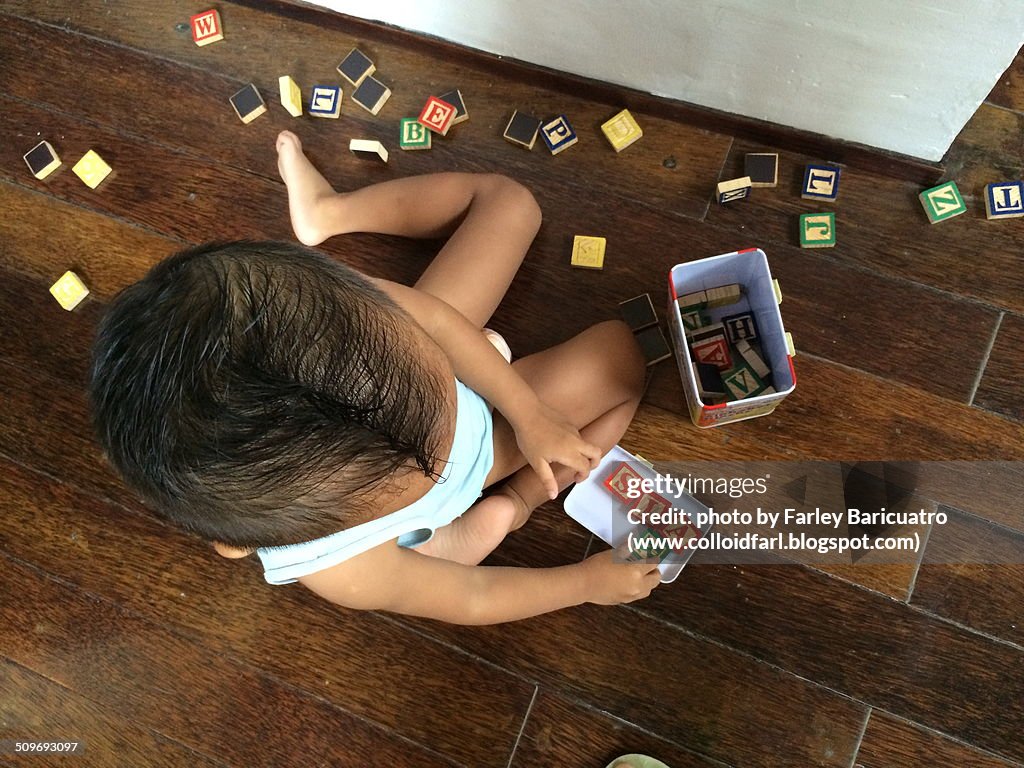 Toddler playing with letters