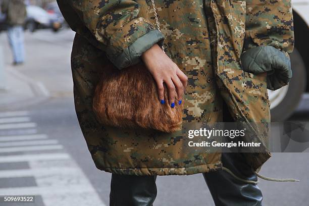 Candice Marie seen at Skylight Clarkson Sq. Outside the Erin Fetherston show wearing camouflage oversized green coat, leather pants and Amiclubwear...