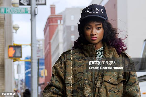 Candice Marie seen at Skylight Clarkson Sq. Outside the Erin Fetherston show wearing camouflage oversized green coat, black cap and Amiclubwear fur...