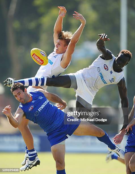 Mason Wood of the Kangaroos and Majak Daw of the Kangaroos compete for the ball over Michael Firrito of the Kangaroos during the North Melbourne AFL...