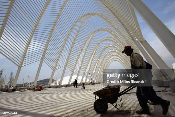 Construction workers continue at a feverish pace at the Agora promenade in the OAKA Olympic Sports Complex ahead of the August Olympic Games on June...