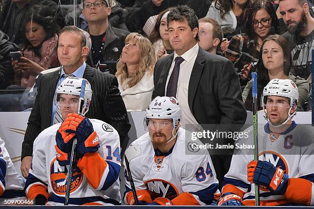 Assistant Coach Greg Cronin, left, and Head Coach Jack Capuano of the New York Islanders, right, watch their team play against the Columbus Blue...