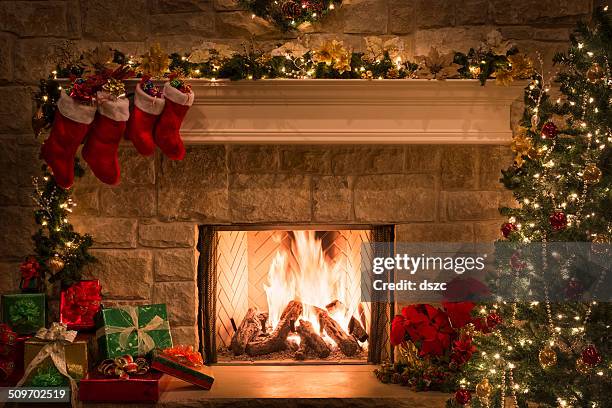 christmas fireplace, stockings, gifts, tree, copy space - row of christmas trees stock pictures, royalty-free photos & images