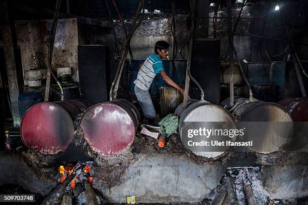 Worker controls the heat of boiler drums during the distillation process of ethanol alcohol at Bekonang village on February 9, 2016 in Sukoharjo,...