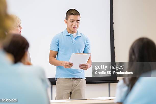 nervous teen student giving presentation in front of class - in front of stockfoto's en -beelden