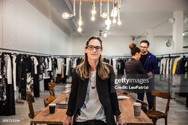 new business employee of a clothing store - kledingwinkel stockfoto's en -beelden