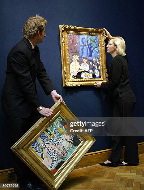 Curators prepare to hang two paintings by Henri Matisse in at Christies in London, 18 June 2004. The painting on the left is entitled "Odalisque au...