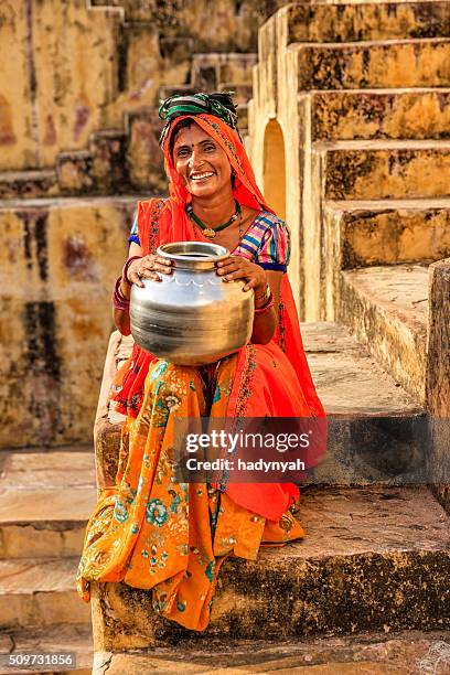 young indian woman in village near jaipur, india - stepwell india stock pictures, royalty-free photos & images