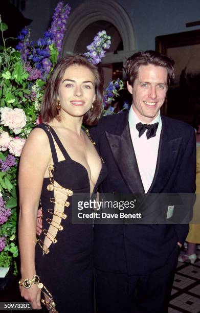 British actor Hugh Grant and his girlfriend Elizabeth Hurley attend the post-premiere party for "Four Weddings And A Funeral" on May 11, 1994 in...