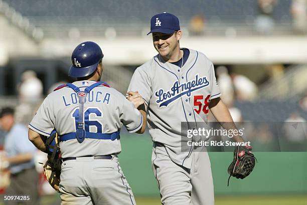 Pitcher Brian Falkenbord shakes the hand of teammate catcher Paul LoDuca of the Los Angeles Dodgers during the game against the Pittsburgh Pirates on...