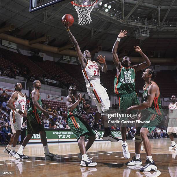 Point guard Terrance Martin of the Huntsville Flight shoots over center Neil Edwards of the North Charleston Lowgators during the NBDL game at the...