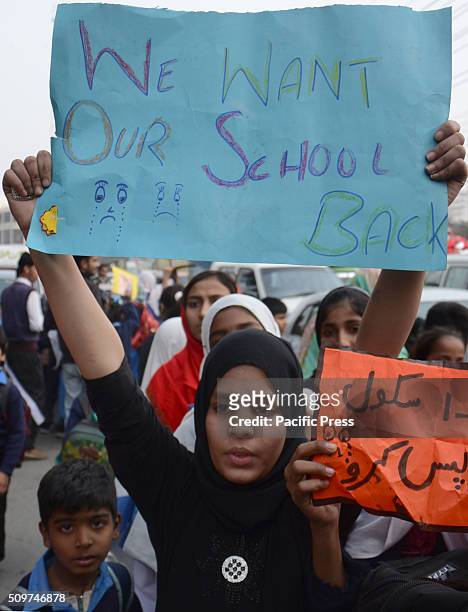 Pakistani students from Government Girls Abualkhair High School holds placards and chant slogans against the transfer of their school to another...