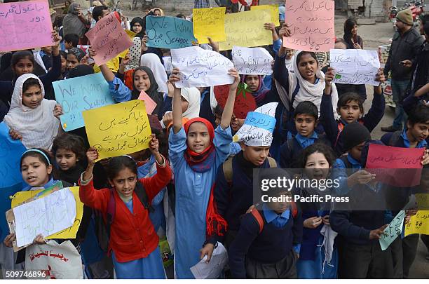 Pakistani students from Government Girls Abualkhair High School holds placards and chant slogans against the transfer of their school to another...