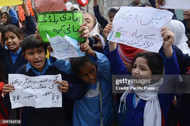 Pakistani students from Government Girls Abualkhair High School holds placards and chant slogans against the transfer of their school to another...