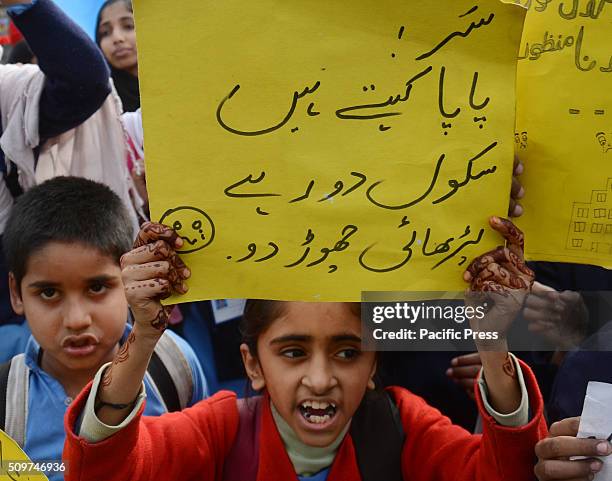 Pakistani students from Government Girls Abualkhair High School holds placards and chant slogans against the transfer of their school to another...