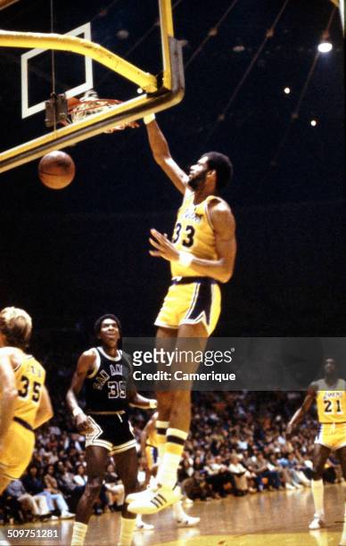 American basketball player Kareem Abdul Jabbar , of the Los Angeles Lakers, dunks the ball against the San Antonio Spurs, September 1982.