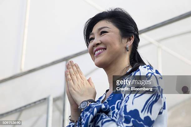 Yingluck Shinawatra, Thailand's former prime minister, greets members of the media during a news conference at her home in Bangkok, Thailand, on...