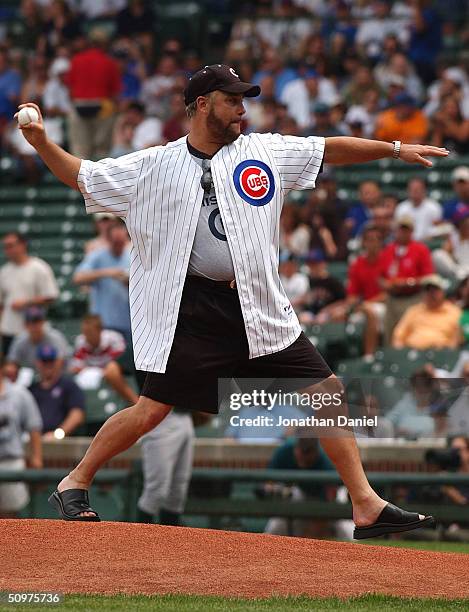 Actor William Petersen throws the ceremonial first pitch before a game between the Chicago Cubs and the Oakland Athletics on June 18, 2004 at Wrigley...