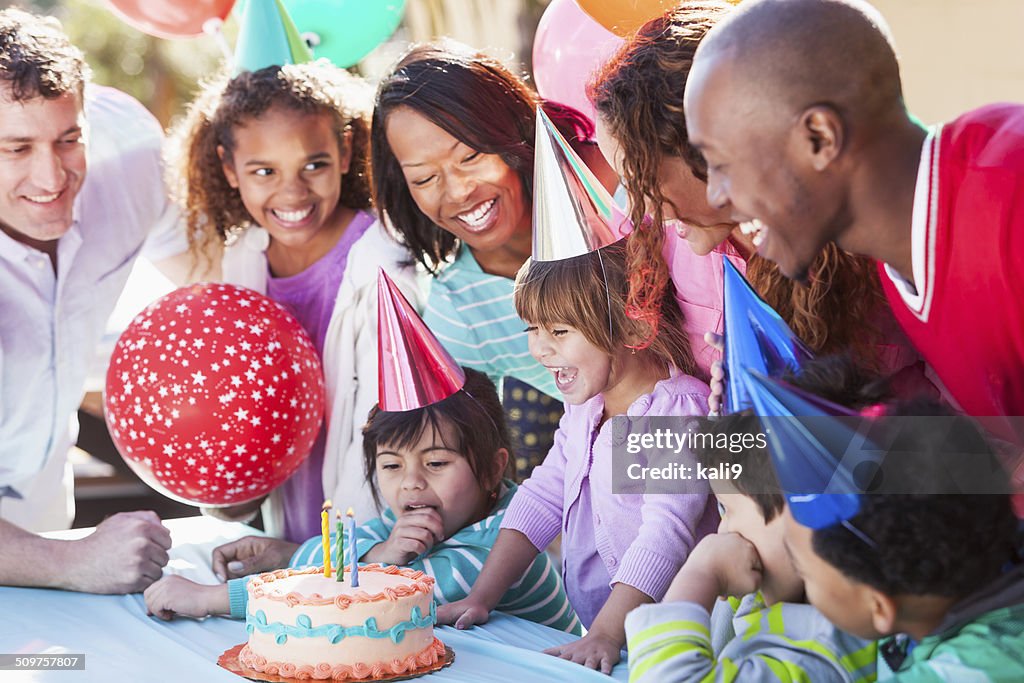 Girl blowing out birthday candles