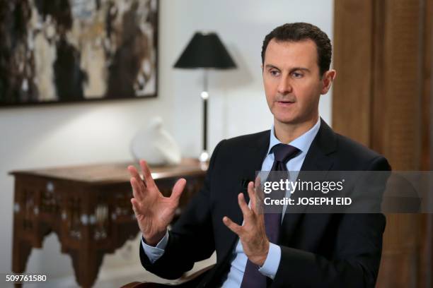 Syrian President Bashar al-Assad gestures during an exclusive interview with AFP in the capital Damascus on February 11, 2016.