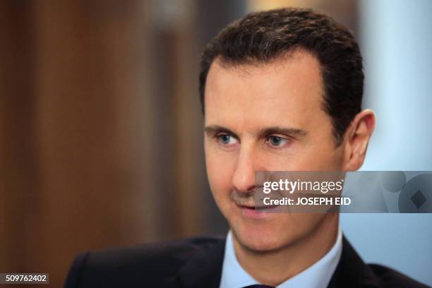 Syrian President Bashar al-Assad listens to a question during an exclusive interview with AFP in the capital Damascus on February 11, 2016.