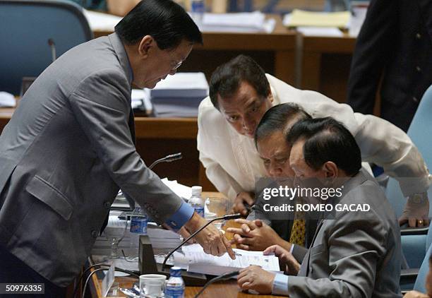 Opposition Senator Sergio Osmena shows documents to, from right, Congressmen Antonio Cuenco, Arthur Defensor and Edgar Chatto during the joint senate...