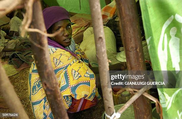 Congolese refugee takes shelter, 19 June 2004, at the Rugombo refugee camp, in Burundi, 20 kms from the Congolese border. Almost 25,000 people have...