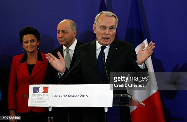 Newly-appointed Foreign Minister Jean-Marc Ayrault delivers a speech next to outgoing French Foreign Minister Laurent Fabius and his companion...