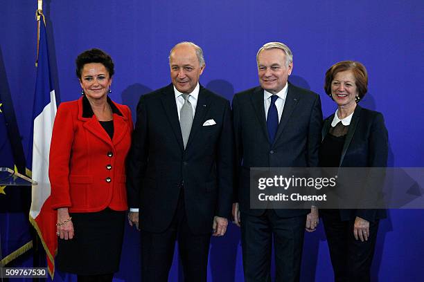 French Foreign Minister Laurent Fabius and his wife Marie-France Marchand-Baylet pose with newly appointed French Foreign Minister Jean-Marc Ayrault...