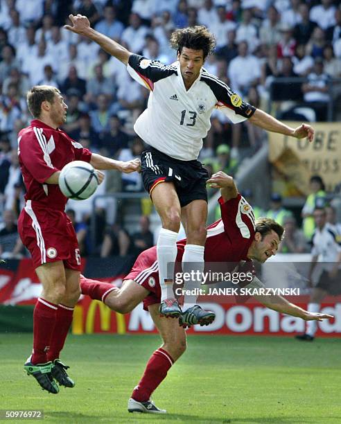 Germany's midfielder Michael Ballack jumps for the ball with Latvian captain Vitalijs Astafjevs , 19 June 2004 during their European Nations...