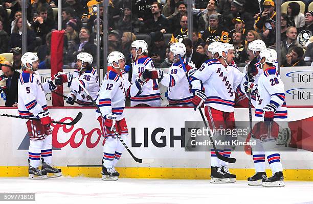 Daniel Paille of the New York Rangers is congratulated by his bench after scoring a goal in the first period during a game against the Pittsburgh...