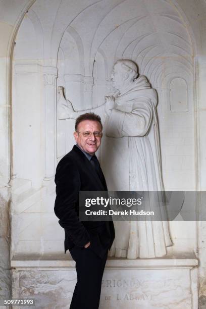 Portrait of oenologist Richard Geoffroy in front of a frieze of benedictine monk Dom Perignon at the Abbey of St Peter, Hautvillers, France, October...