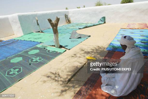Muslim man prays 19 June, 2004 under a tree at a mosque built 200 years ago at Gudu district of Sokoto State of northern Nigeria, where Shehu Usman...