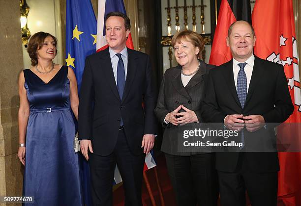 British Prime Minister David Cameron , German Chancellor Angela Merkel , Hamburg's Mayor Olaf Scholz and his wife Britta Ernst attend the annual...