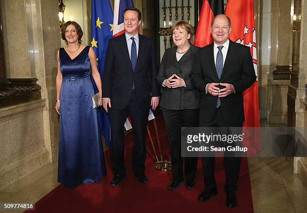 British Prime Minister David Cameron , German Chancellor Angela Merkel , Hamburg's Mayor Olaf Scholz and his wife Britta Ernst attend the annual...
