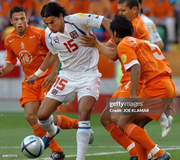 Czech Republic's forward Milan Baros vies with Netherlands' defender John Heitinga, defender Wilfred Bouma and defender Giovanni Van Bronckhorst , 19...